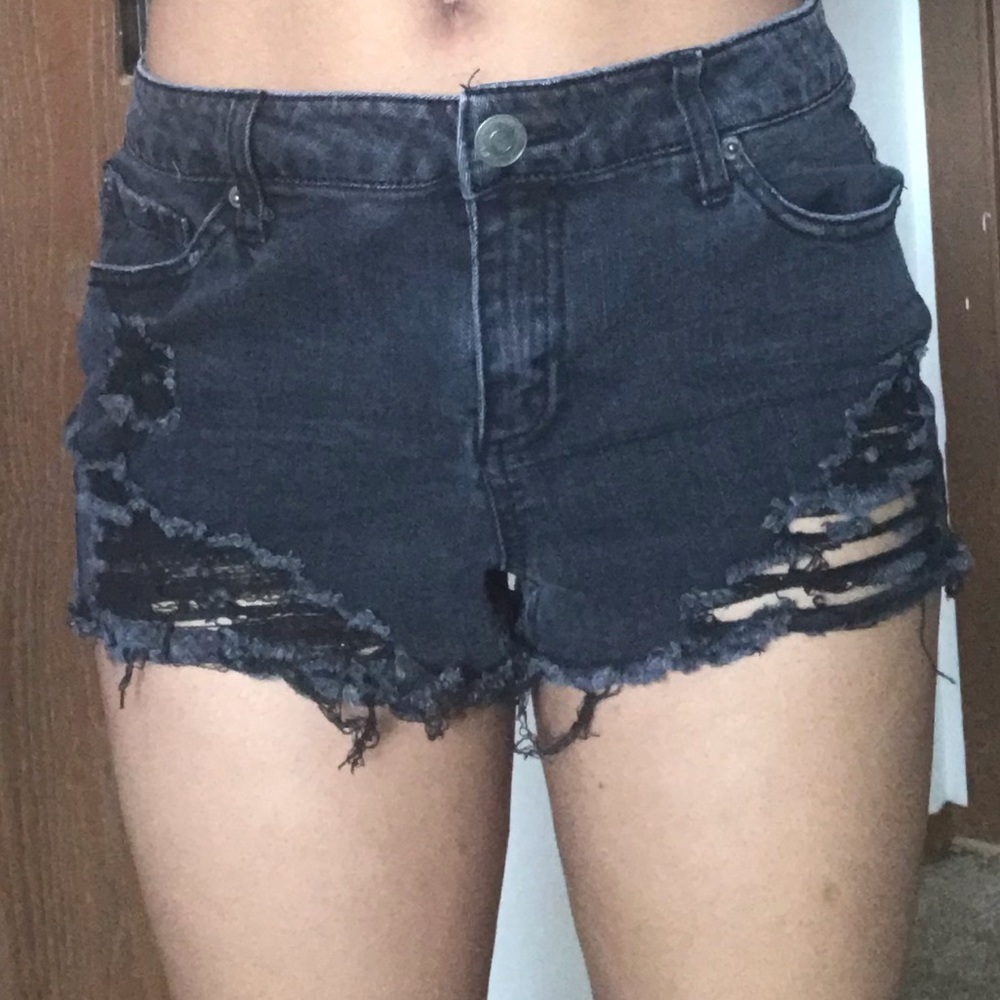 Ripped black summer shorts. They rise a little.